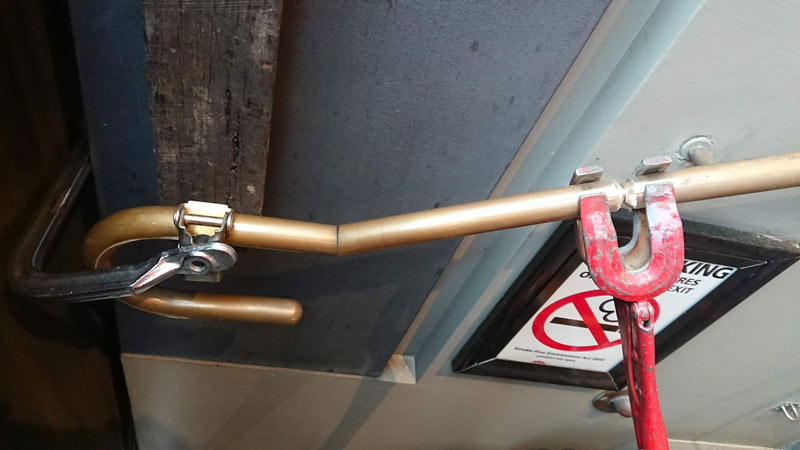 Brass handrail repair onsite - before